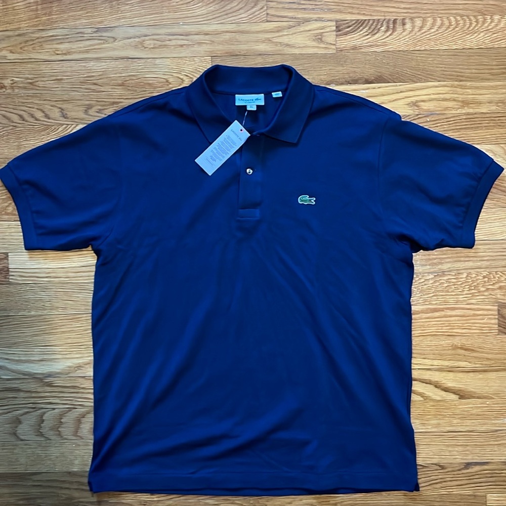 Brand New Never Been Worn and tags still on it. Blue Lacoste polo shirt.